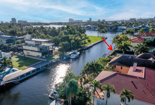 an aerial view of a house with a garden and lake view