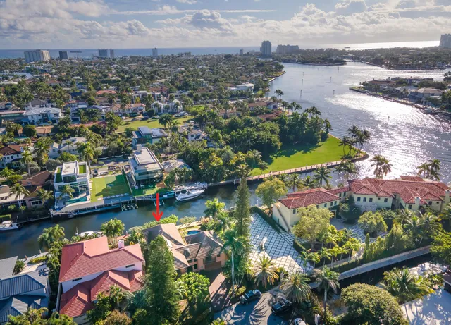 an aerial view of a houses with a lake view
