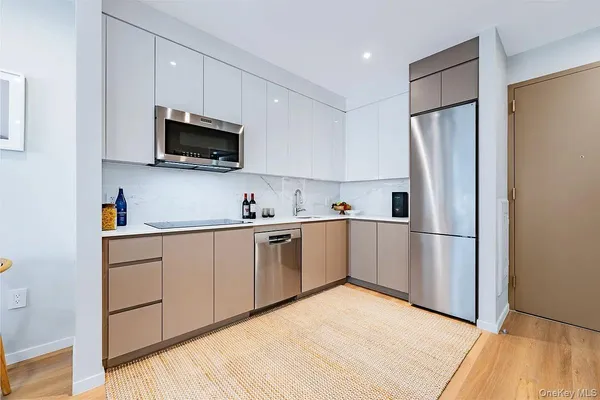 a kitchen with stainless steel appliances white cabinets and a sink