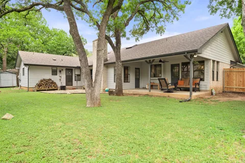 a view of a house with backyard porch and sitting area