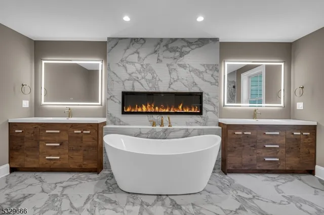 a spacious bathroom with a tub sink and mirror