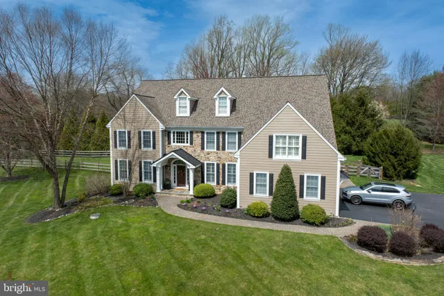 a front view of a house with a garden and yard