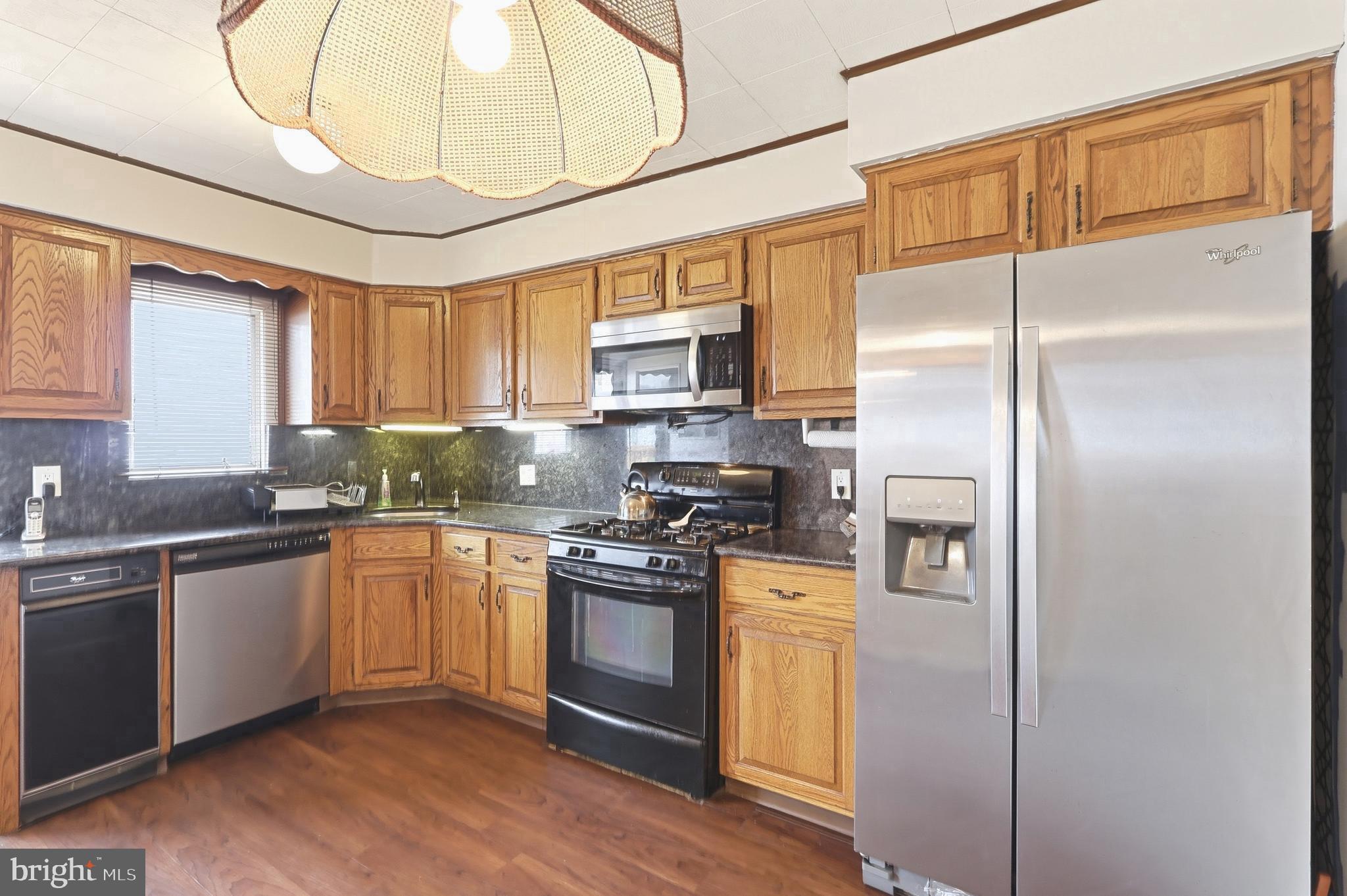 123 Pocasset Road Philadelphia, PA 19115 - Photo 14 of 35 a kitchen with stainless steel appliances granite countertop a stove a sink dishwasher a refrigerator and a microwave