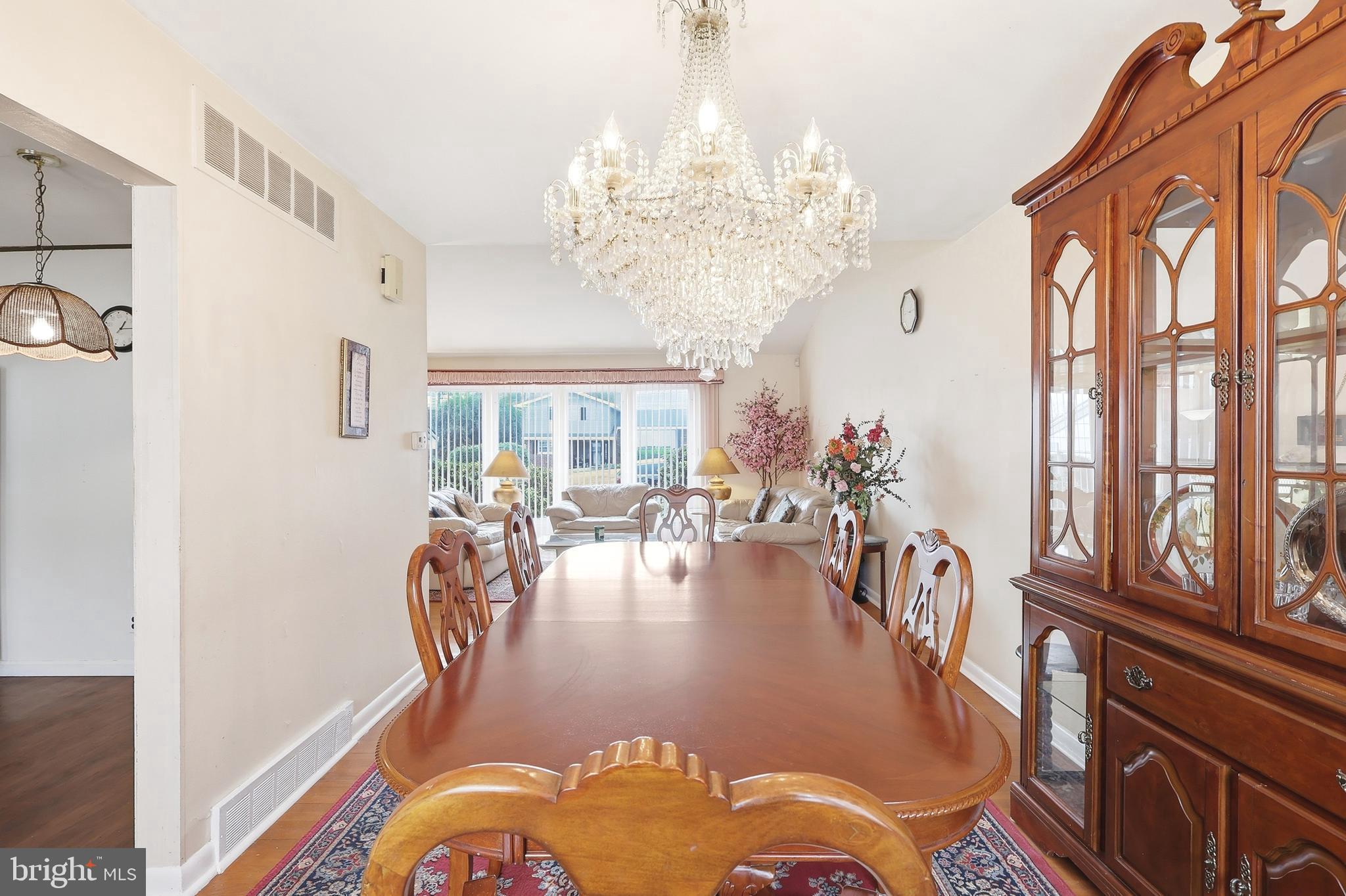 123 Pocasset Road Philadelphia, PA 19115 - Photo 16 of 35 a view of a dining room with furniture a chandelier and large windows