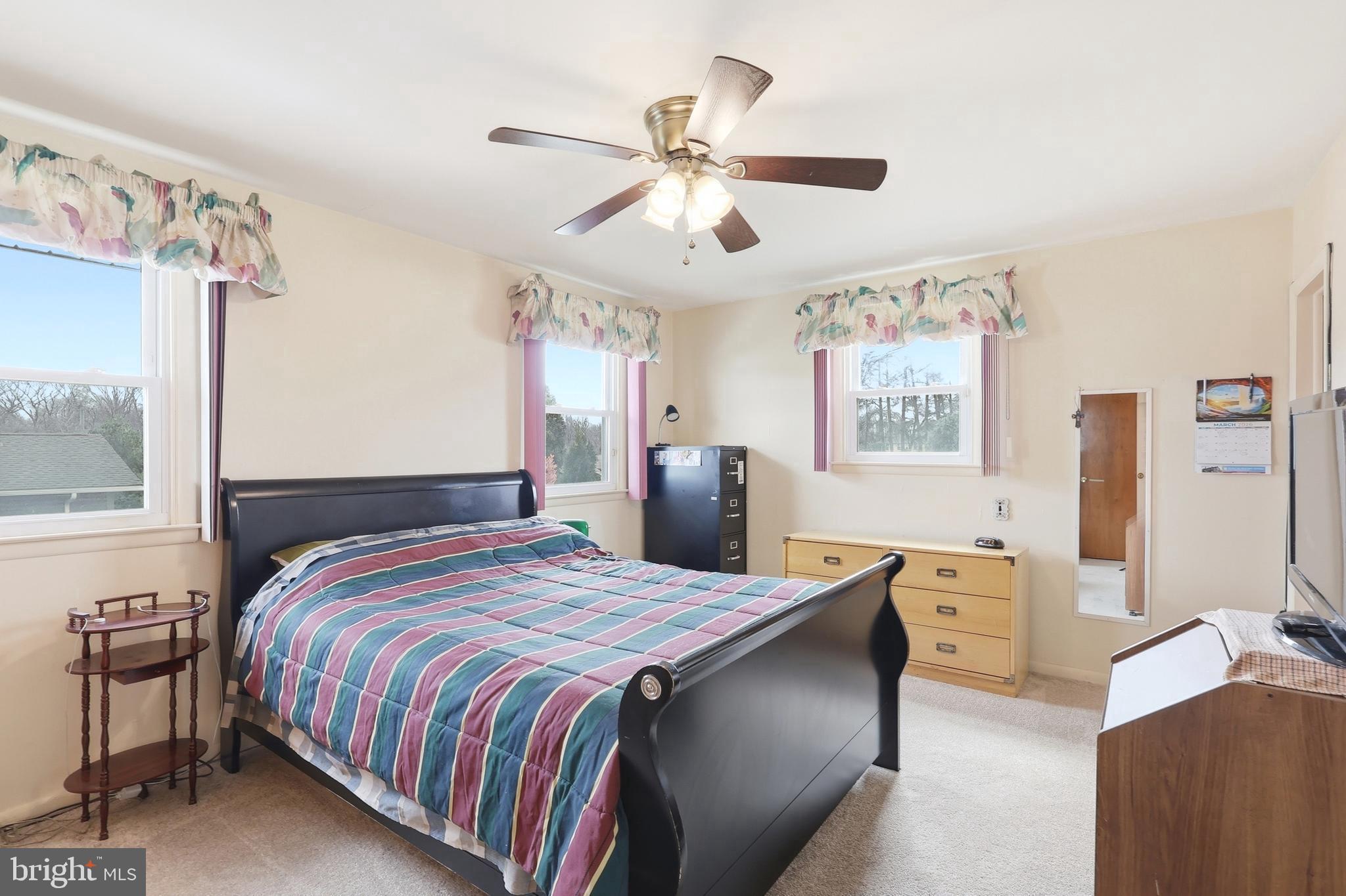 123 Pocasset Road Philadelphia, PA 19115 - Photo 19 of 35 a bedroom with a bed and a chandelier