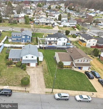 an aerial view of a residential houses with outdoor space