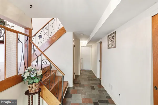 a very nice looking hallway with wooden floor and stairs