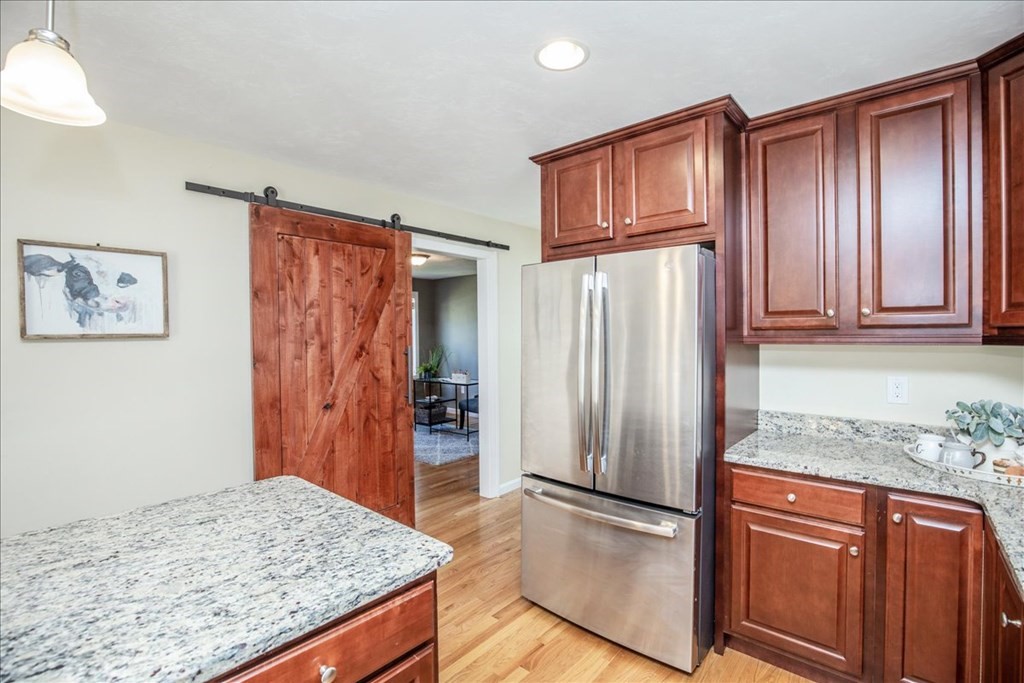 294 River Street Billerica, MA 01821 - Photo 15 of 42 a kitchen with stainless steel appliances granite countertop a refrigerator and a stove top oven