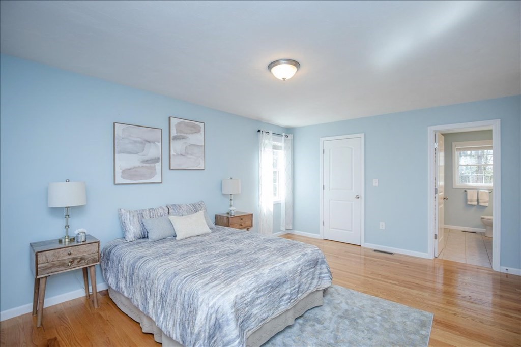 294 River Street Billerica, MA 01821 - Photo 25 of 42 a bedroom with a bed and a lamp