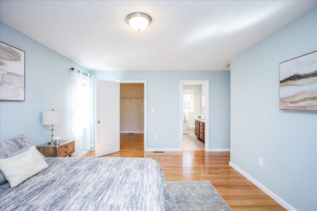 294 River Street Billerica, MA 01821 - Photo 26 of 42 a spacious bedroom with a bed and wooden floor