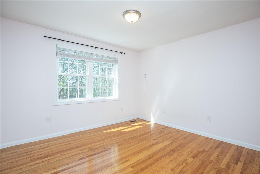 294 River Street Billerica, MA 01821 - Photo 29 of 42 an empty room with wooden floor and windows