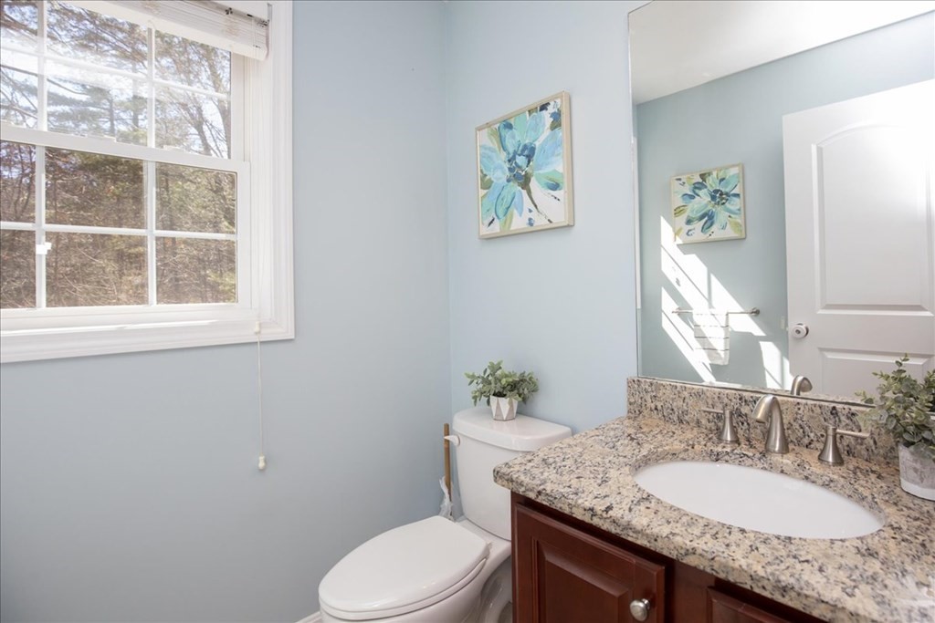 294 River Street Billerica, MA 01821 - Photo 33 of 42 a bathroom with a granite countertop toilet sink and mirror