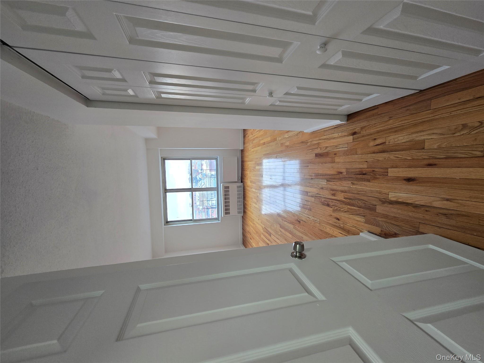 34-12 113th Street, Unit 7L Queens, NY 11368 - Photo 2 of 9 a view of a room with wooden floor and staircase