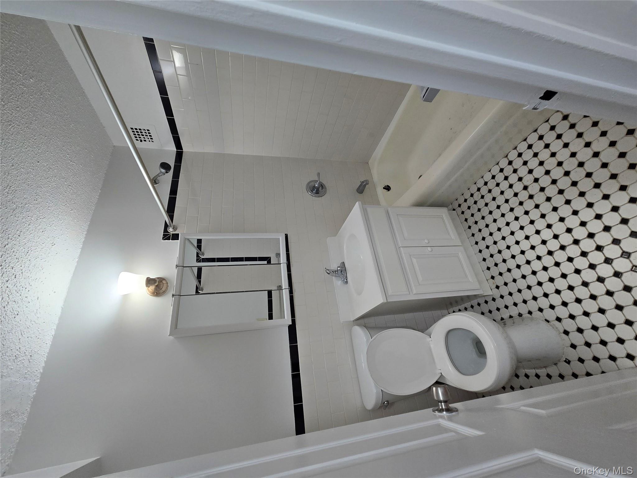 34-12 113th Street, Unit 7L Queens, NY 11368 - Photo 5 of 9 a bathroom with a sink toilet and shower