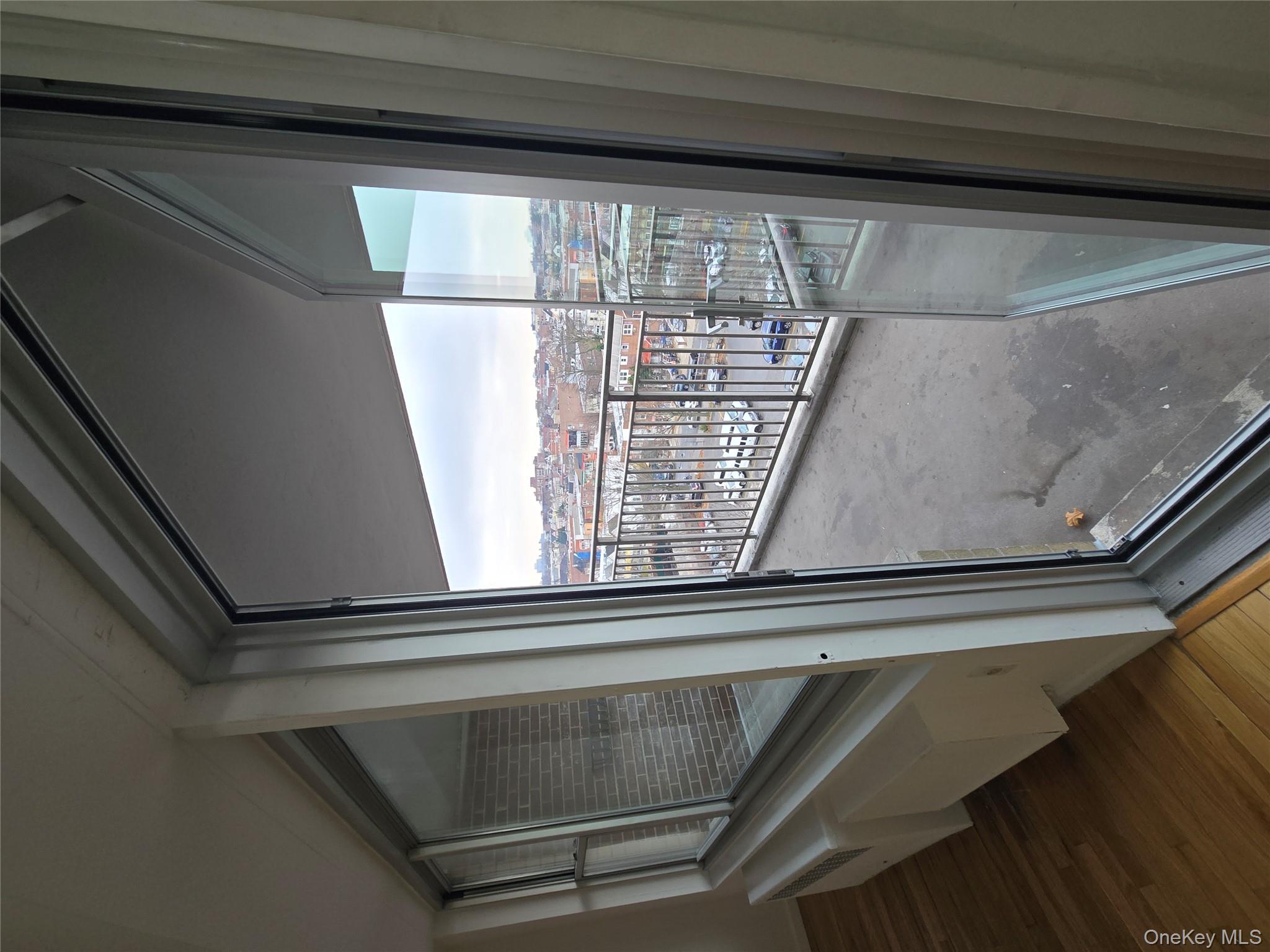 34-12 113th Street, Unit 7L Queens, NY 11368 - Photo 7 of 9 a view of a glass door with a glass door