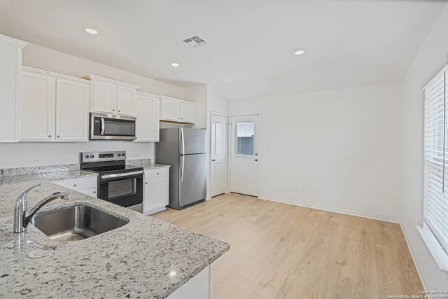 a kitchen with a sink stove and refrigerator