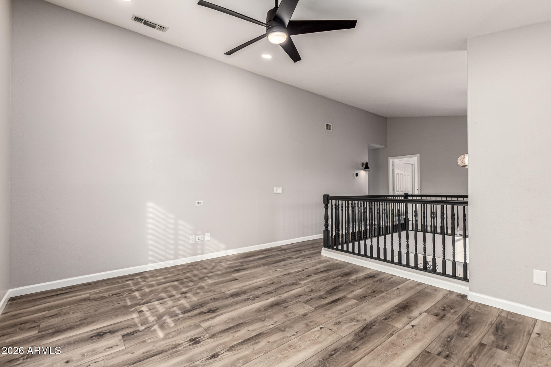 6455 East Raftriver Street Mesa, AZ 85215 - Photo 16 of 36 a view of a hallway with wooden floor