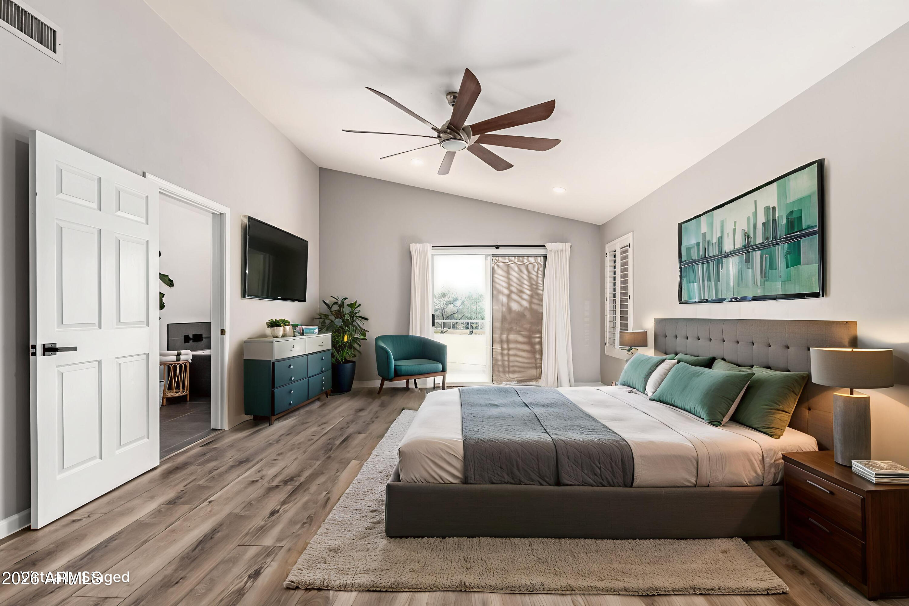 6455 East Raftriver Street Mesa, AZ 85215 - Photo 17 of 36 a bedroom with a bed and a flat screen tv