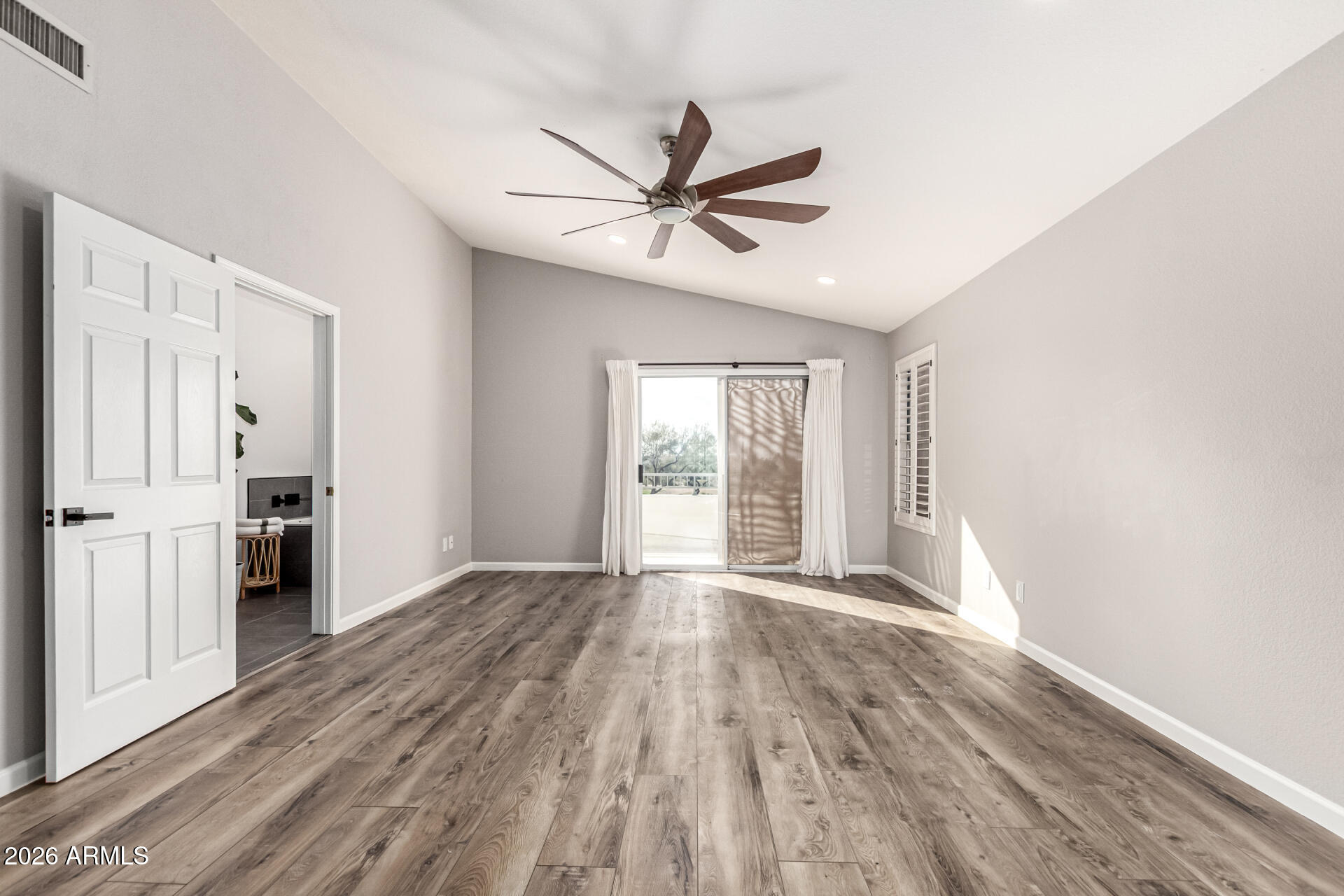 6455 East Raftriver Street Mesa, AZ 85215 - Photo 18 of 36 a view of empty room with wooden floor and fan
