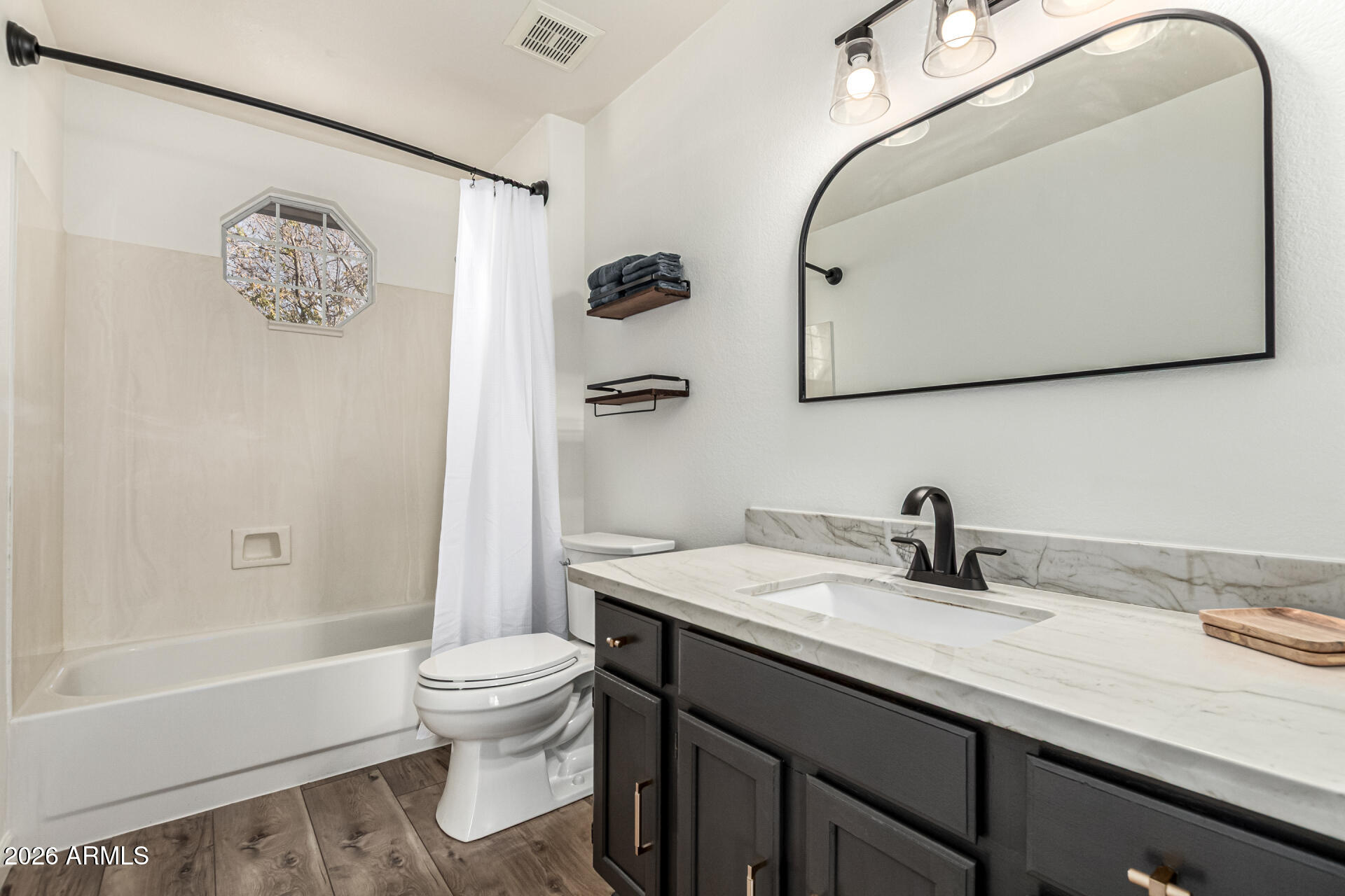 6455 East Raftriver Street Mesa, AZ 85215 - Photo 25 of 36 a bathroom with a granite countertop sink a toilet and a bathtub