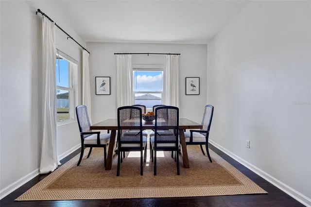 a view of a a dining room with furniture and wooden floor