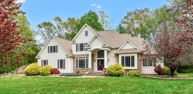 a front view of a house with a garden and plants