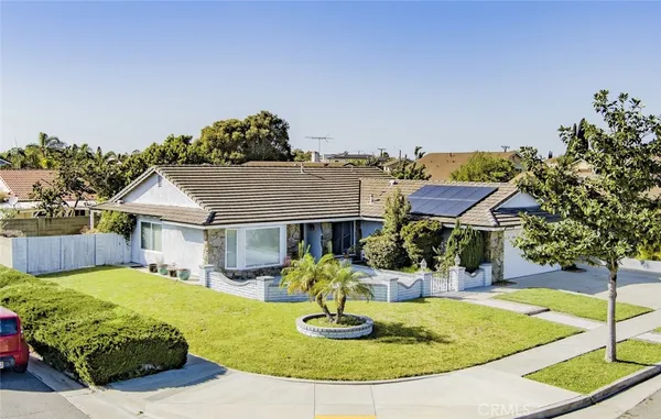 a view of a house with swimming pool and a yard