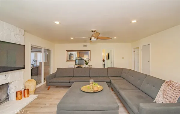 a kitchen with stainless steel appliances granite countertop a refrigerator a stove a sink dishwasher and a dining table with the view of kitchen