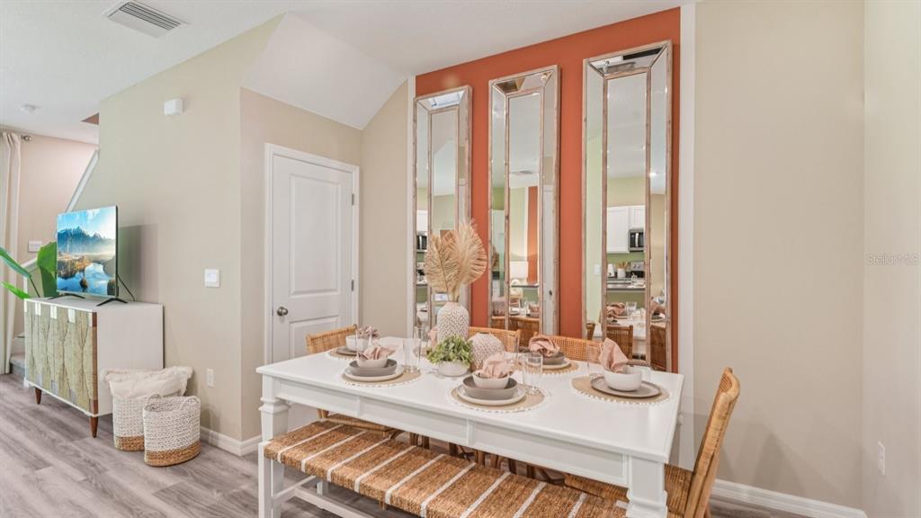 32455 Welling Blade Loop Wesley Chapel, FL 33545 - Photo 10 of 42 a view of a dining room with furniture and wooden floor