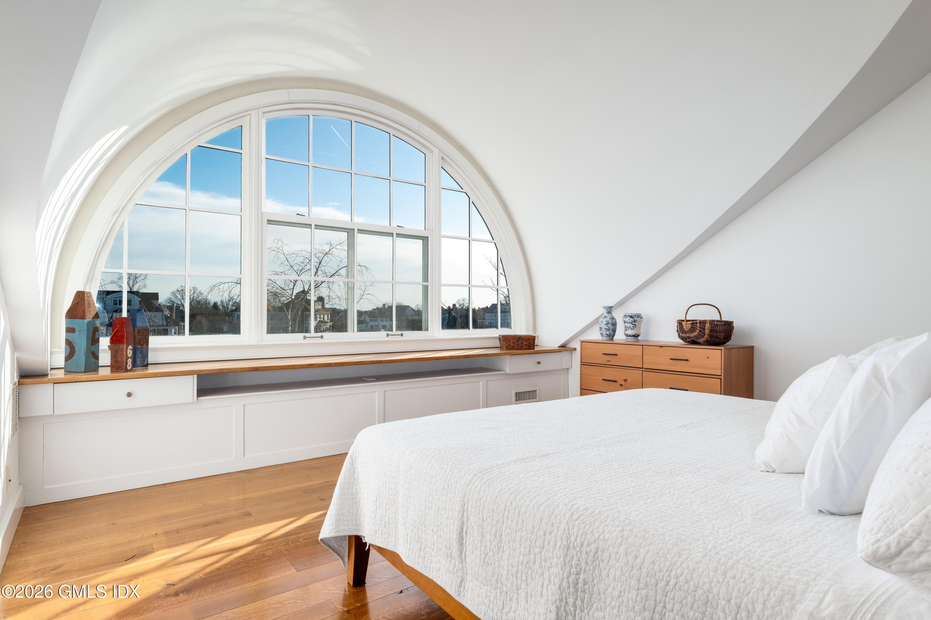 189 Shore Road Old Greenwich, CT 06870 - Photo 25 of 38 a bedroom with a large bed and a large window