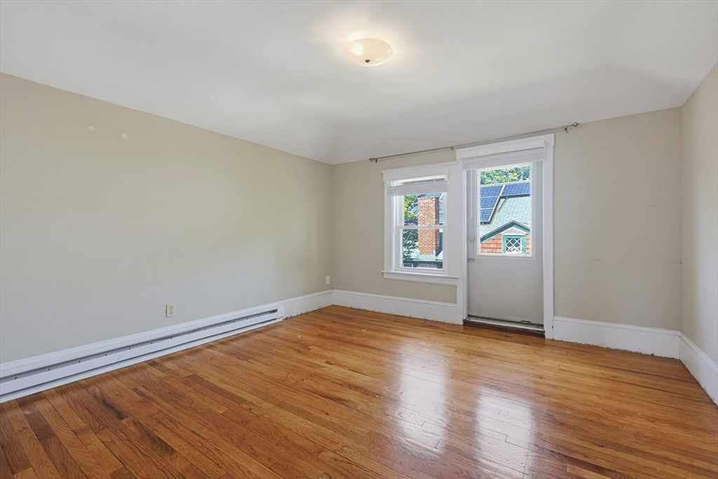 157 Elm Street Somerville, MA 02144 - Photo 14 of 19 wooden floor in an empty room with a window
