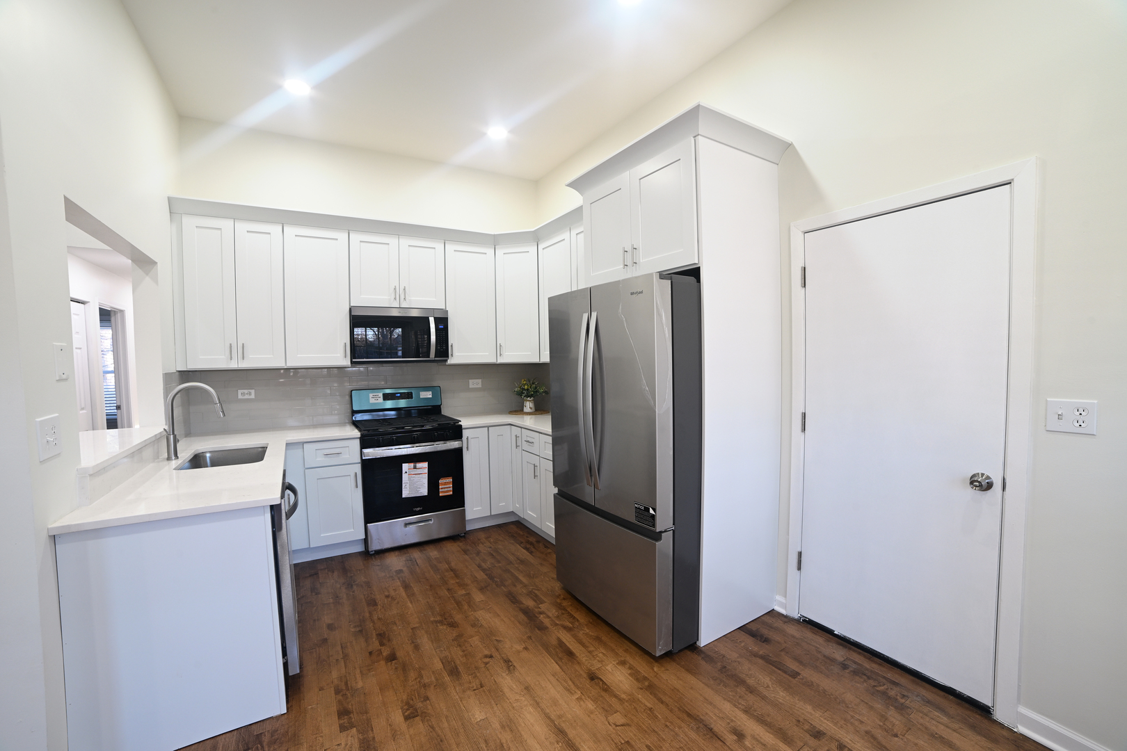 1944 Navarone Drive Naperville, IL 60565 - Photo 3 of 6 a kitchen with a refrigerator cabinets stainless steel appliances and wooden floor