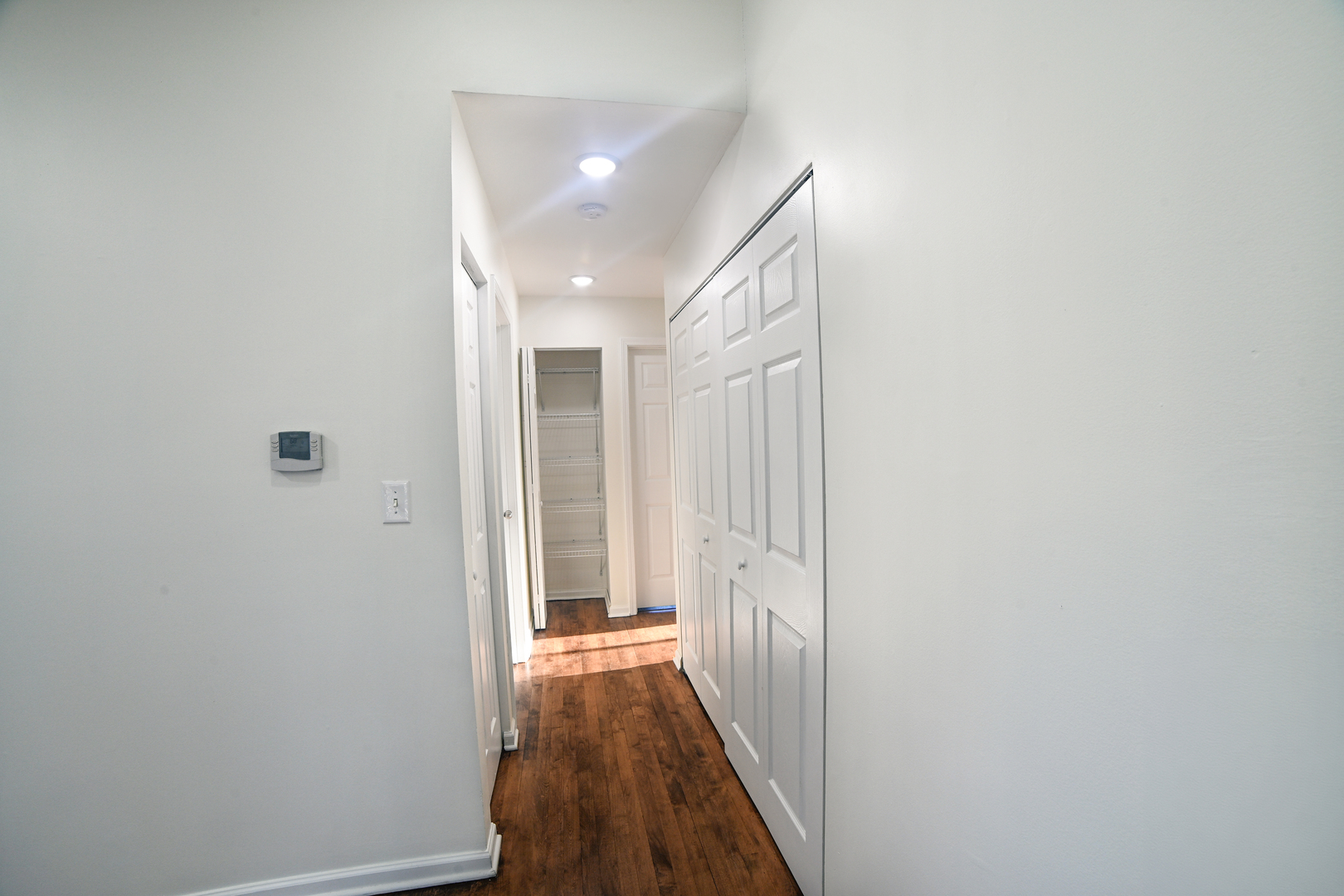 1944 Navarone Drive Naperville, IL 60565 - Photo 5 of 6 a view of a hallway with wooden floor