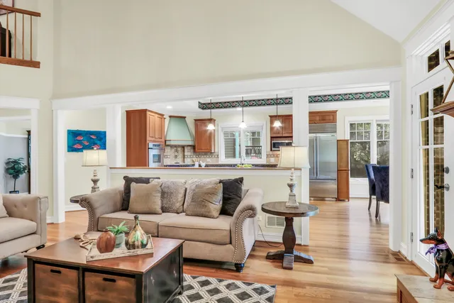 a living room with furniture and view of kitchen