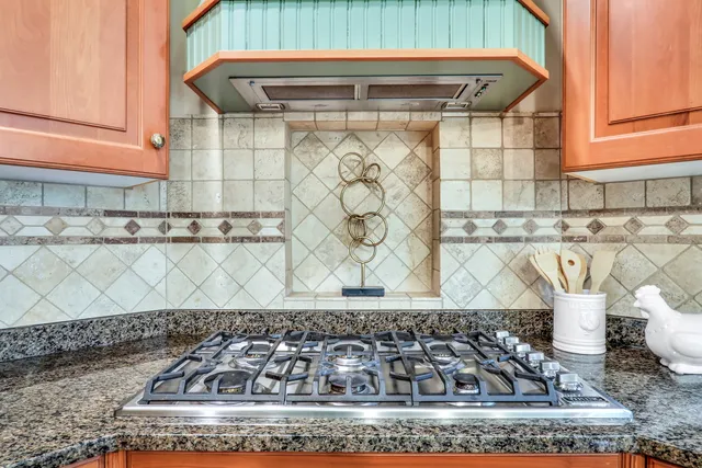 a bathroom with a granite countertop sink and a stove