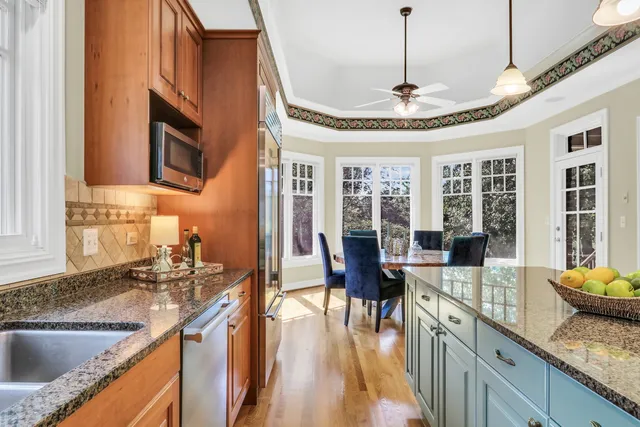 a kitchen with stainless steel appliances granite countertop a stove and a sink
