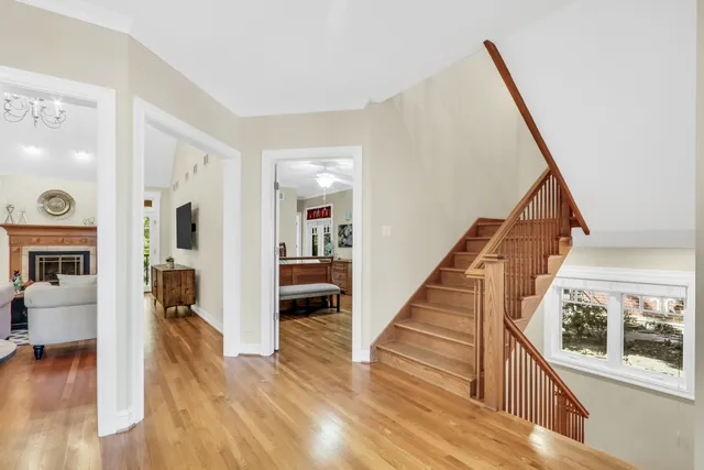 a view of a hallway view with wooden floor and staircase
