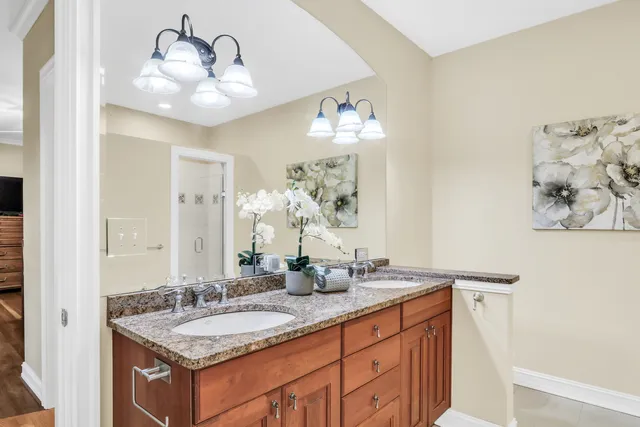 a bathroom with a granite countertop sink a large mirror and vanity