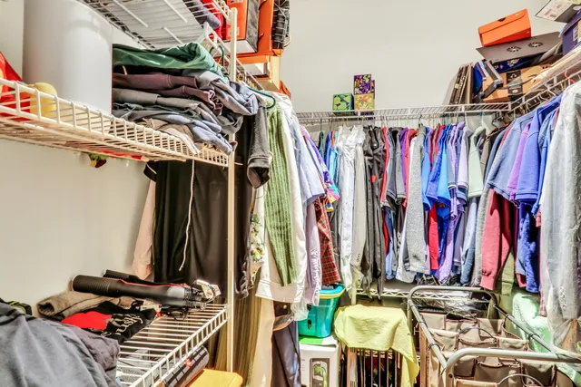a view of walk in closet with clothes