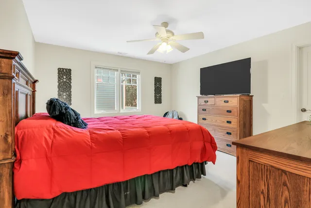 a bed room with a bed window and a flat screen tv