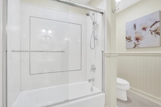 a bathroom with a shower and a toilet