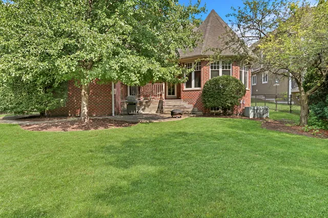 a view of a house with a yard and sitting area