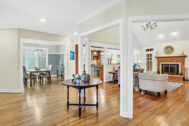a living room with fireplace furniture and a table