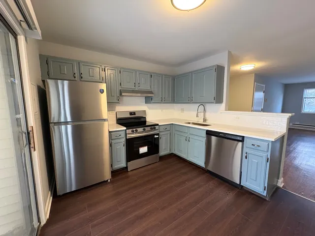 a kitchen with a refrigerator and a sink