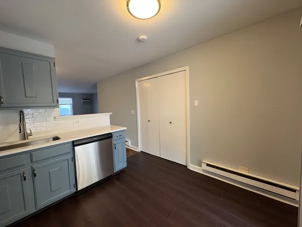 a kitchen with sink cabinets and wooden floor