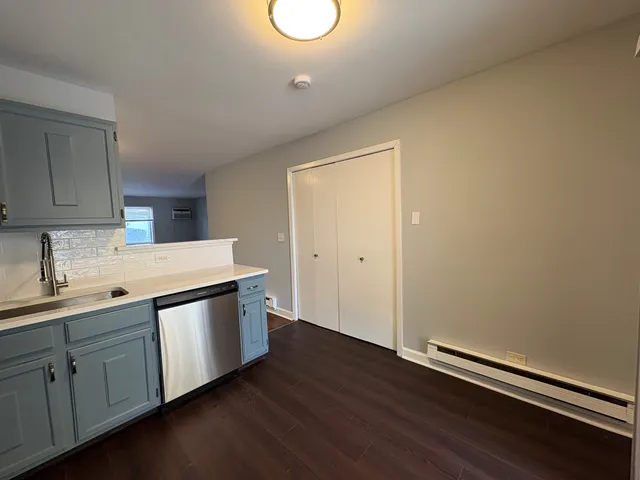 a kitchen with sink cabinets and wooden floor