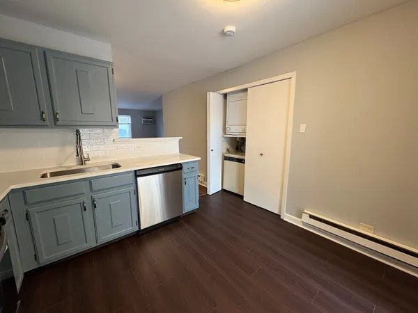 a kitchen with cabinets and wooden floor