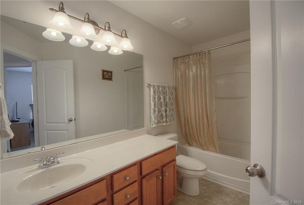 6831 Maricopa Road Charlotte, NC 28277 - Photo 17 of 23 a bathroom with a sink a toilet a mirror and shower