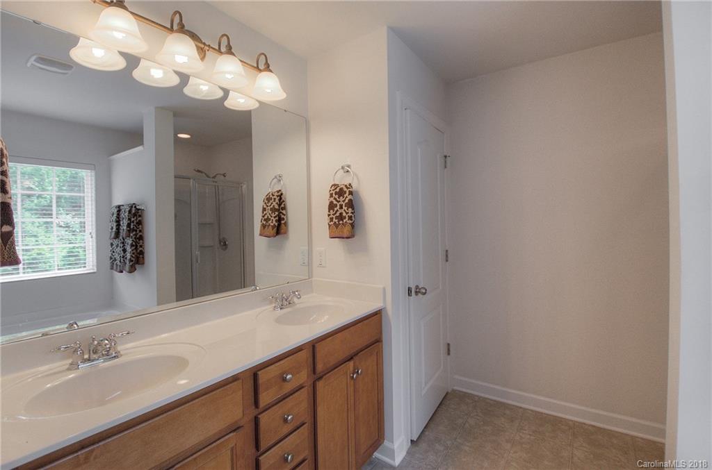 6831 Maricopa Road Charlotte, NC 28277 - Photo 19 of 23 a bathroom with a sink vanity and a mirror