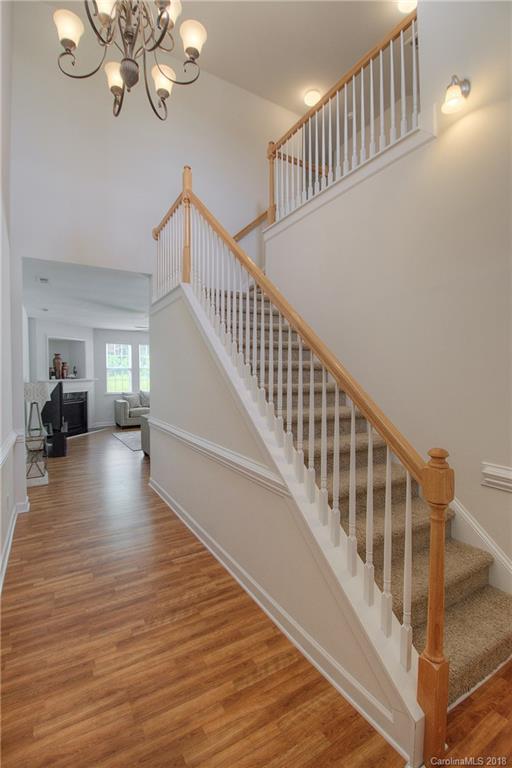 6831 Maricopa Road Charlotte, NC 28277 - Photo 5 of 23 a view of staircase with wooden floor and a chandelier